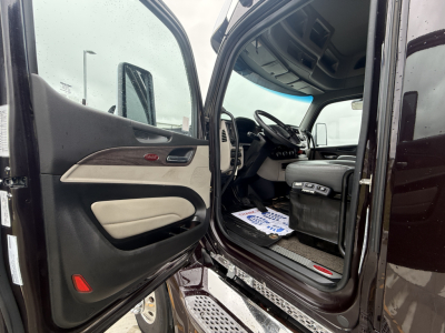 Peterbilt 579 cab interior and open driver door showing steering wheel and dashboard from entry view