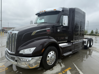 Peterbilt 579 conventional sleeper truck with black paint, chrome bumper, and dual rear axles. Visible text includes Peterbilt badge on grille and side emblem; appears on a used listing with VIN 1XPBD49X7RD897620 and stock number 0632267.