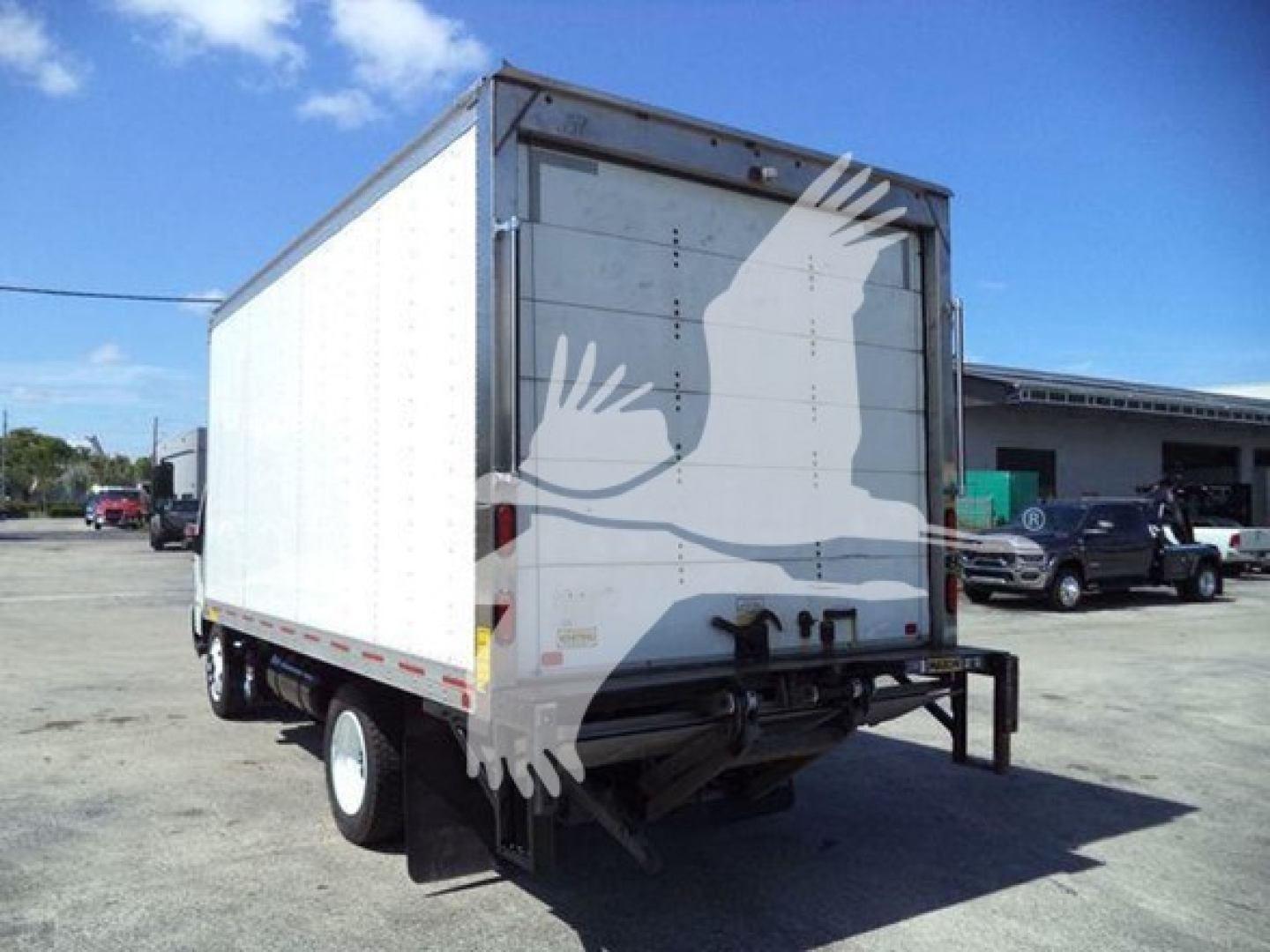 Box truck rear view showing cargo box and undercarriage with dual rear wheels.