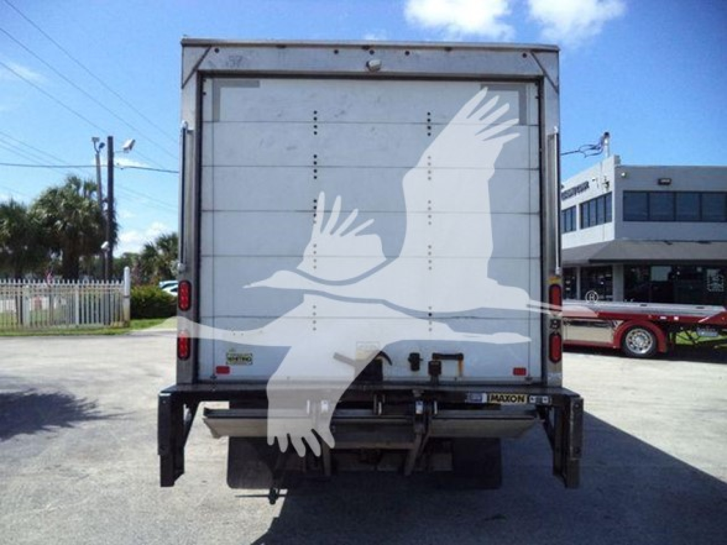 Rear view of a 2020 Hino 195 box truck showing stock decals and dual rear doors.