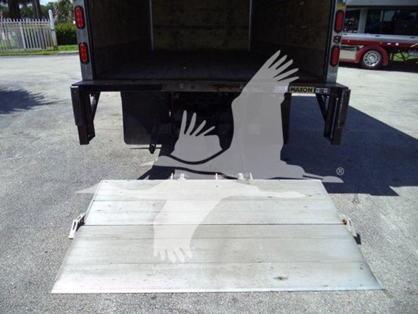 Hino 195 box truck with fold-down aluminum ramp at rear showing cargo area and tailgate