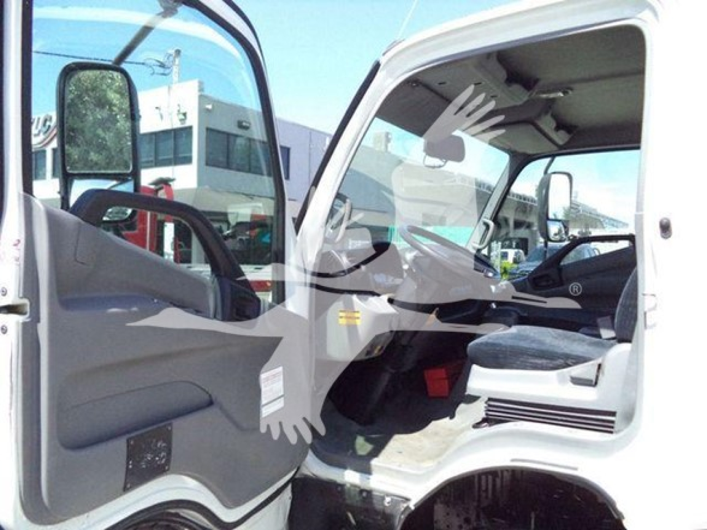 Hino 195 truck interior cab view showing driver seat and dashboard with open door