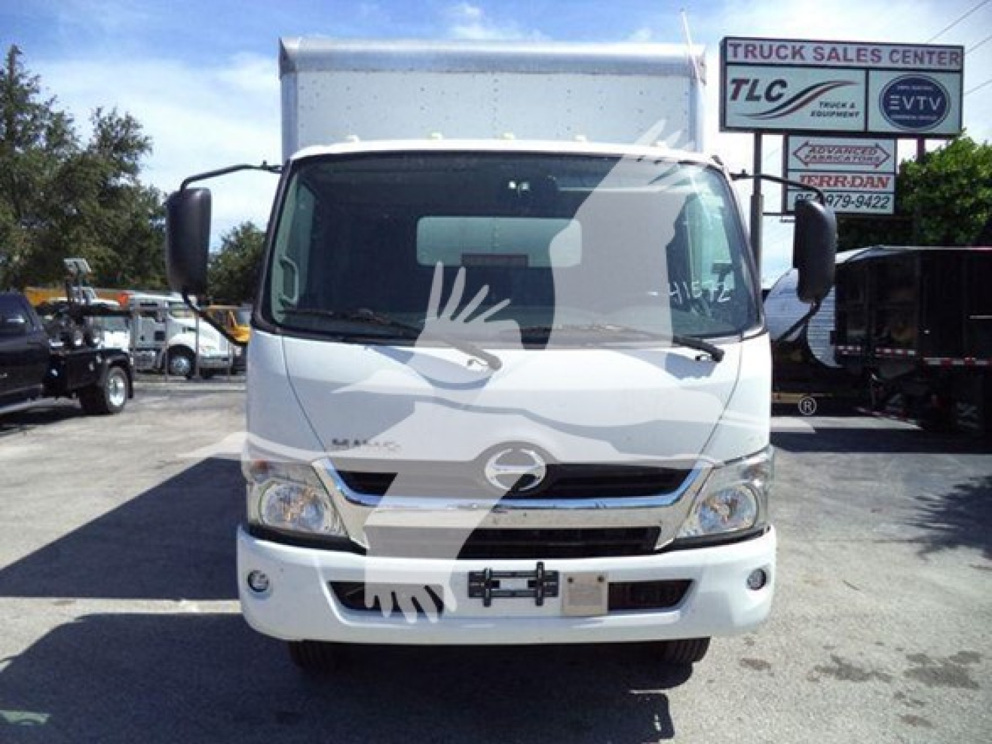 Front view of a white 2020 Hino 195 box truck showing grille, headlights, and windshield with side mirrors.