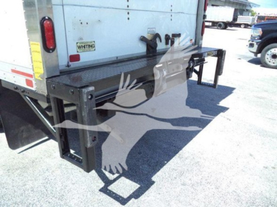 Rear view of a used 2020 Hino 195 box truck showing a fold-out aluminum lift or bumper step with black support frame and rear bumper, VIN tag not visible.