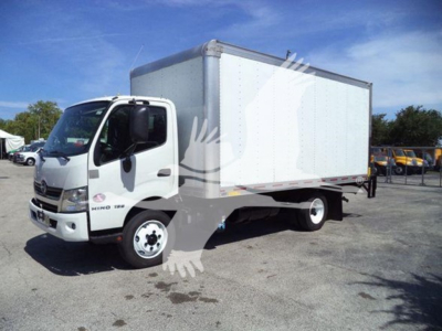 Box trucks with a white cab and a large white box body, Hino logo on the door, side view showing cab and cargo box.