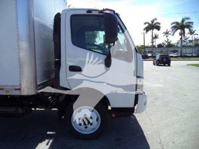 2020 Hino 195 box truck cab front-right view showing white cab and side mirror, with box trailer attached.