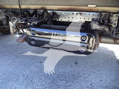 Underbody view of a 2020 Hino 195 truck showing a polished cylindrical fuel tank or exhaust component mounted underneath the frame, with metallic brackets and wiring nearby.