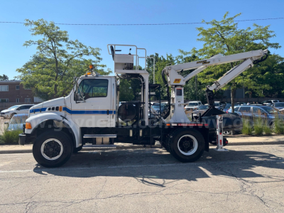 Grapple truck side view showing elevated platform, crane arm, and hydraulic hooks with white cab and blue stripe