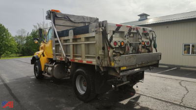 Dump truck showing rear and side of 2002 Sterling L8500 with dump body and safety lights.