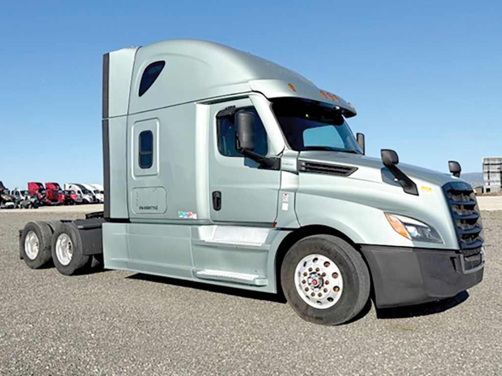 Freightliner Cascadia126 tractor-trailer cab side view showing Freightliner emblem and sleeper area.
