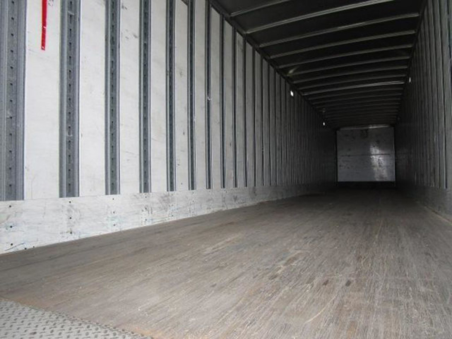 Interior of a 2014 Stoughton van trailer showing empty cargo area with wooden floor and metal side walls.