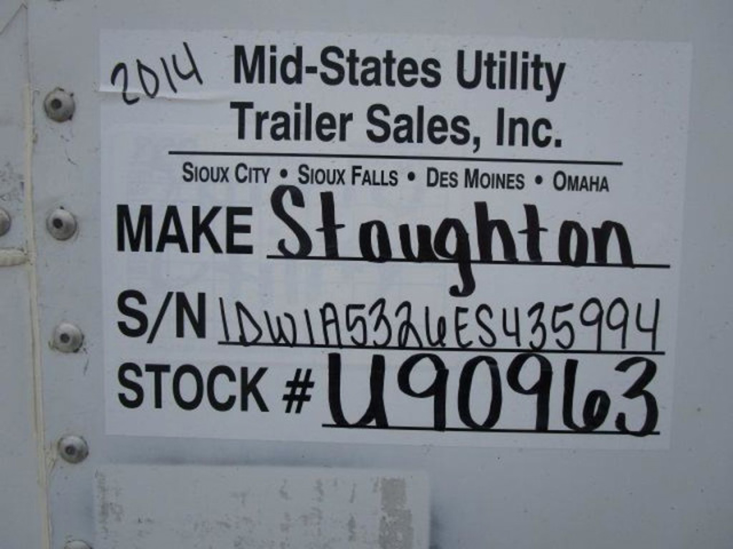 Sign on trailer indicating 2014 Mid-States Utility Trailer Sales, Inc. Make Stoughton; S/N U090963; Stock U90963; VIN 1DW1A5326ES435994; stock number visible on plate.