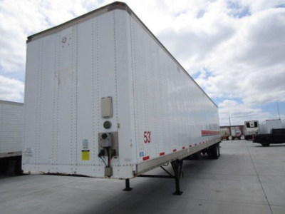 Side view of a white 2014 Stoughton van trailer with landing legs down, VIN 1DW1A5326ES435994, stock U90963, number 53 on the side, parked in lot.
