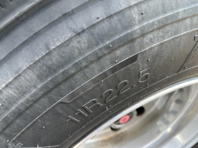 Trailer tire showing embossed tire size 11R22.5.