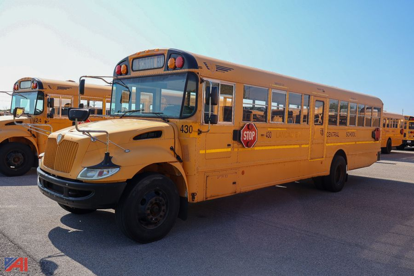 IC Corporation CE Series school bus with stop sign and yellow body; visible text includes school bus markings and number 430 on the front side.