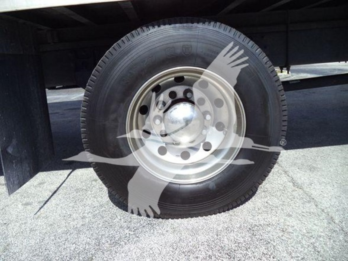 Wheel and tire of a refrigerated truck undercarriage showing steel wheel and hub; no visible text.