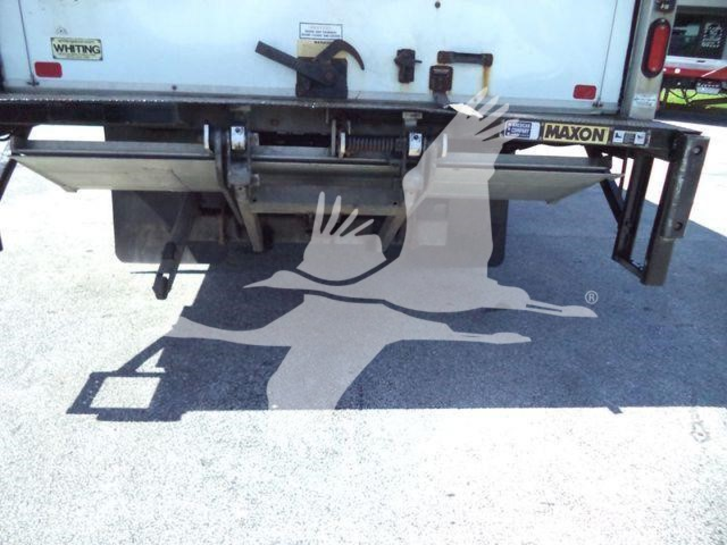 Rear view of a 2020 Hino 195 box truck showing tailgate and Maxon lift gate with visible labels.