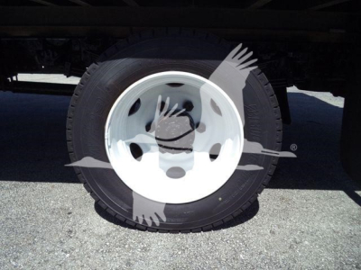 Wheel and tire of a Hino 195 truck showing white steel rim and black tire.