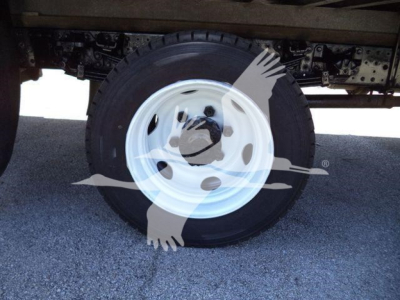 Wheel and tire on a Hino 195 box truck chassis showing white steel wheel and black tire.