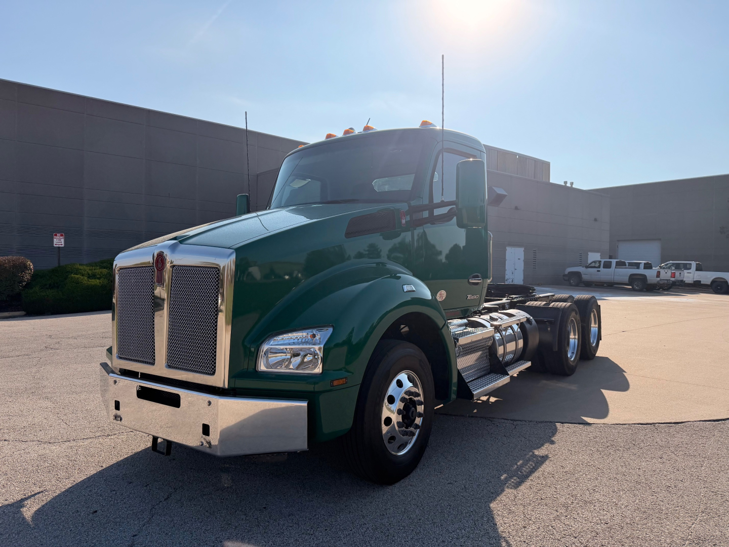 Kenworth T880 conventional daycab truck in dark green is shown from front-left angle.