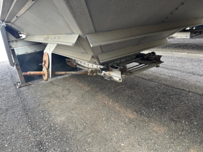 Trailed image showing underside of a 2008 Wilson grain trailer hopper with axle-less front and hitch, showing frame and support hardware.