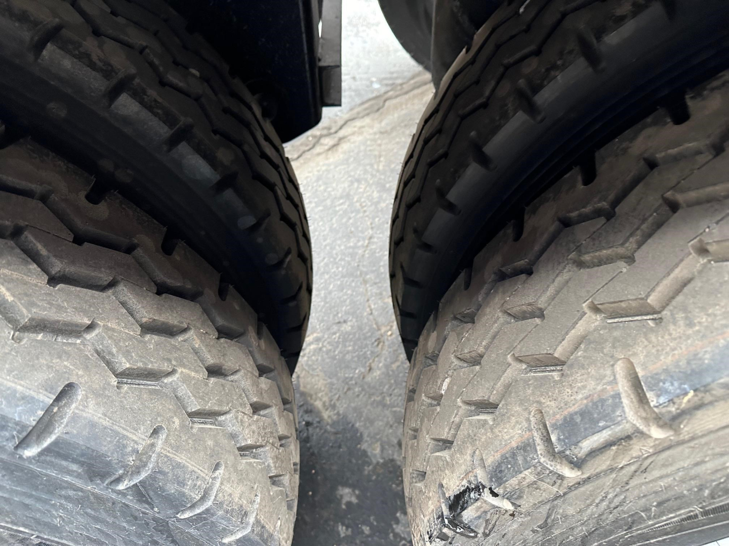 Image shows two large off-road trailer tires side by side with treads visible.