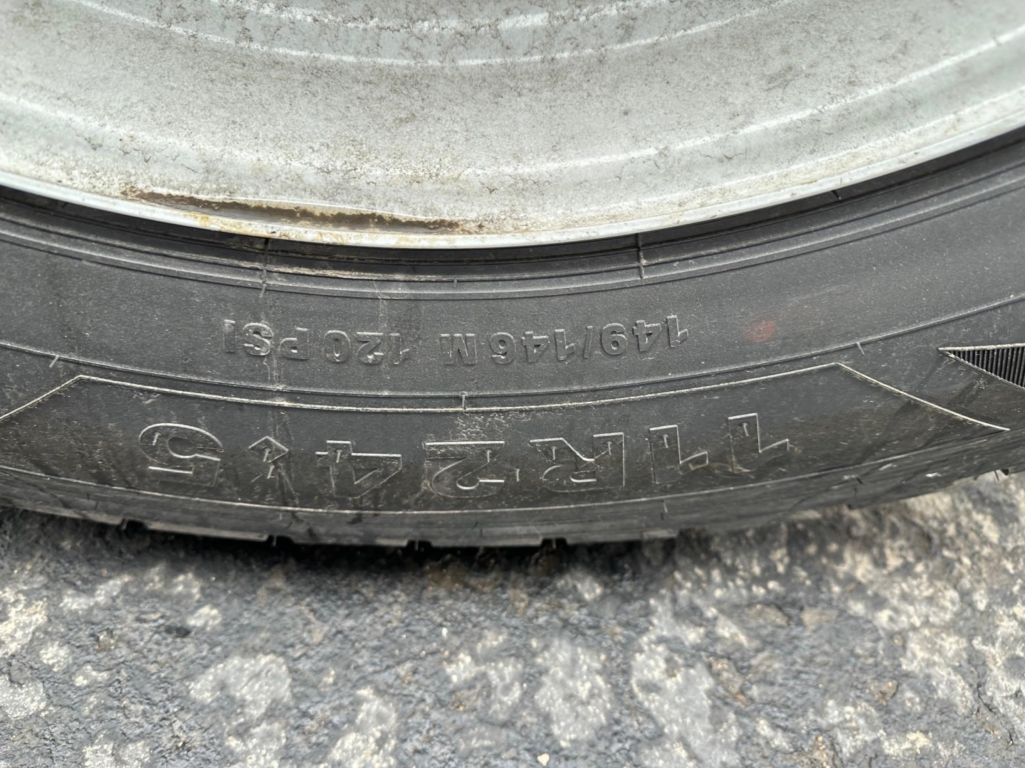 Tire sidewall with numbers and letters including 13 0Z? N? and 4??; tire tread and rim visible