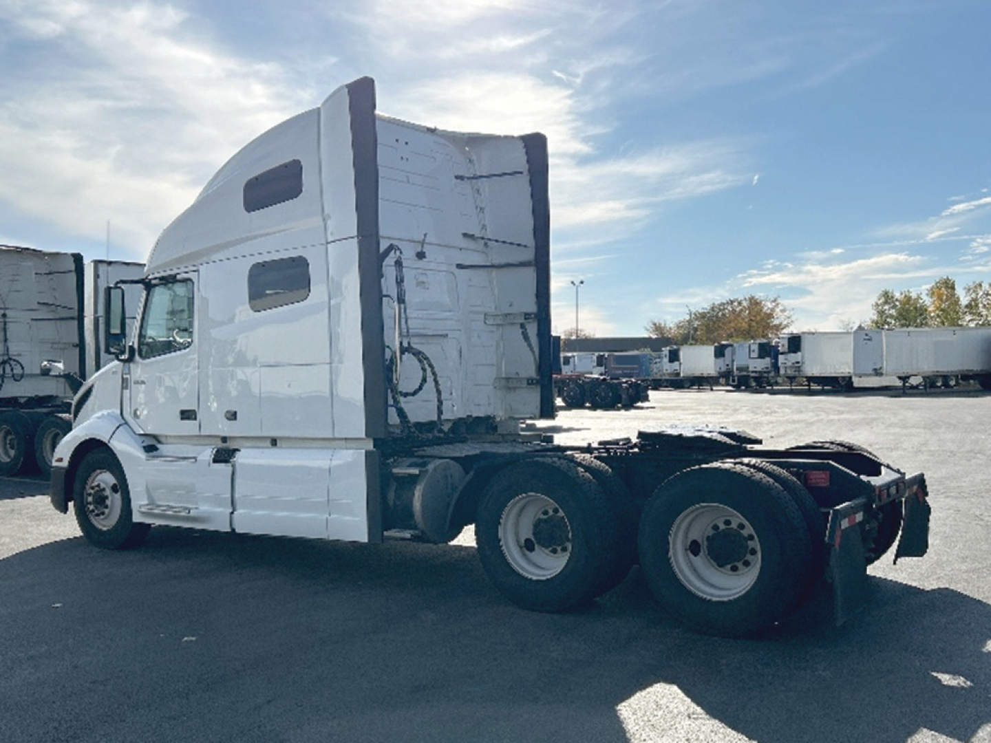 Truck side view showing sleeper cab and rear wheels of a Volvo VNL 760 tractor with no visible door text.