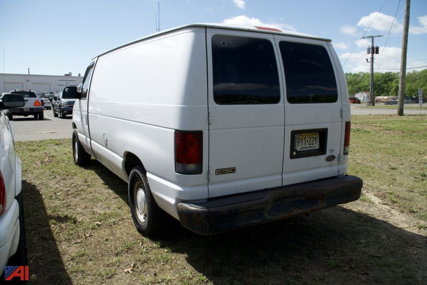 Ford E-Series cargo van rear view showing blank rear doors and license plate, white exterior, cargo van