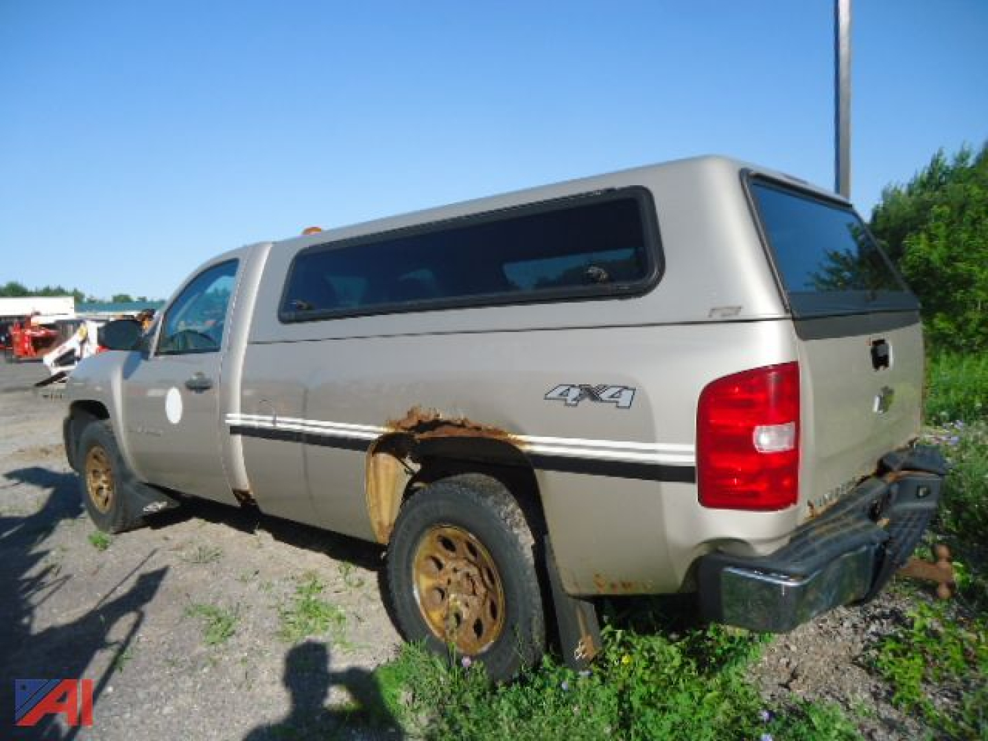 2008 Chevrolet Silverado 1500 pickup with long bed and cap, side view showing rusted wheel well and 4x4 badge.