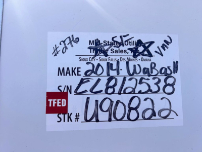 Tag on trailer with handwritten and printed text: 'Make 2014 Wabash', VIN '1JJV532D8EL812538', S/N 'EL812538', STK # '1490822', TFED label visible. MF State Utility Sales Omaha listing tag.