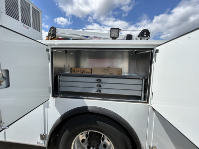 MD6 service body with open side compartment showing a set of drawers and storage boxes inside.