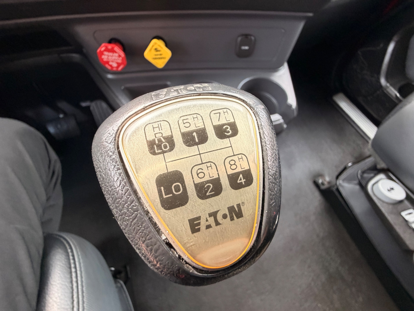 Kenworth T680 gear shifter with shift pattern graphic visible, showing PRND and 1-8 gears, in-cab view