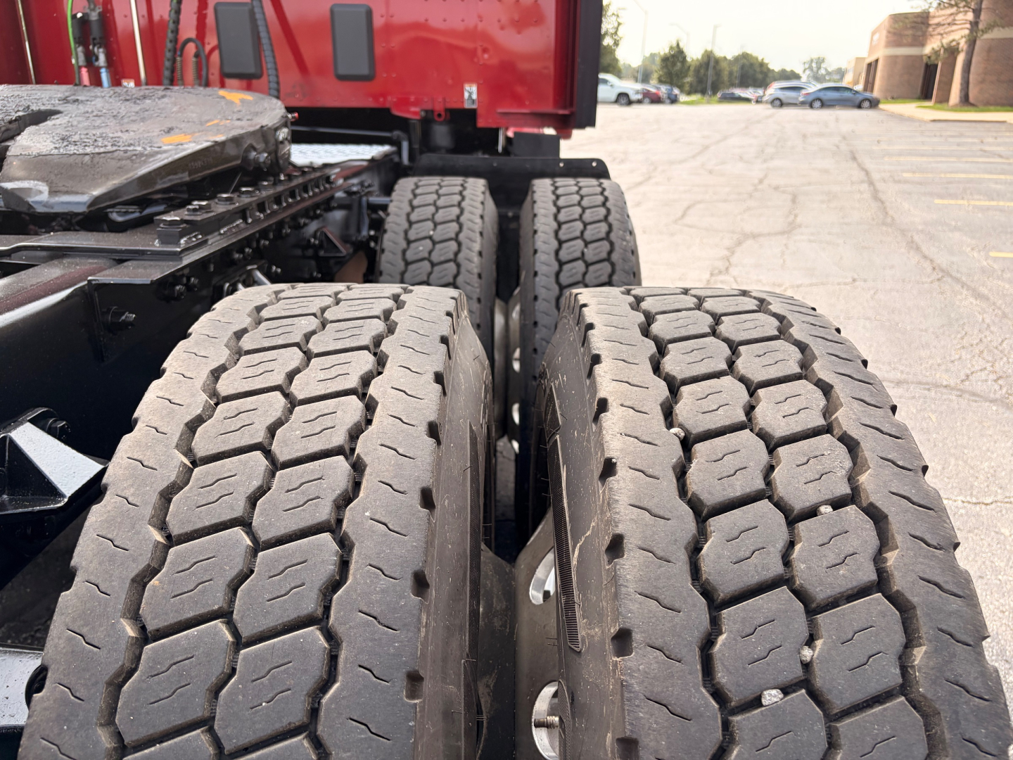 Kenworth T680 truck rear dual wheels and drive axles showing tire treads and chassis.