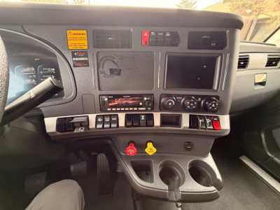 Kenworth T680 interior dashboard showing control panel, switches, vents, and cupholders
