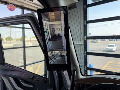 Volvo VNL64T860 truck cab interior with mounted tablet screen showing a view of the showroom.