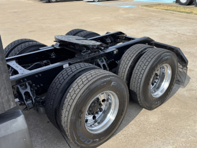 Kenworth T680 chassis with dual rear axles and tires, view focused on rear wheel area.
