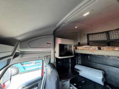 Kenworth T680 sleeper cab interior showing bunk area and storage shelves