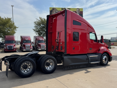Kenworth T680 conventional sleeper truck side view showing red cab and black chassis.