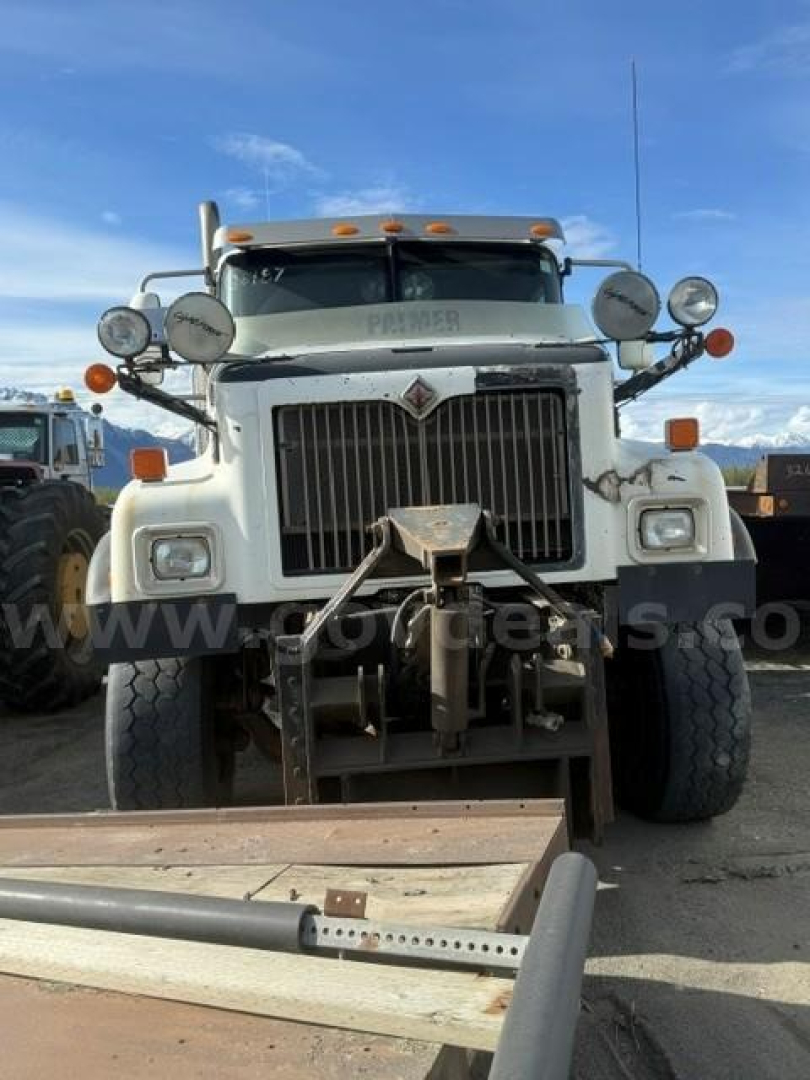 Truck front view of a 2007 International 5500i plow truck with large grille, dual headlights, multiple auxiliary lights, and a plow mounting apparatus.
