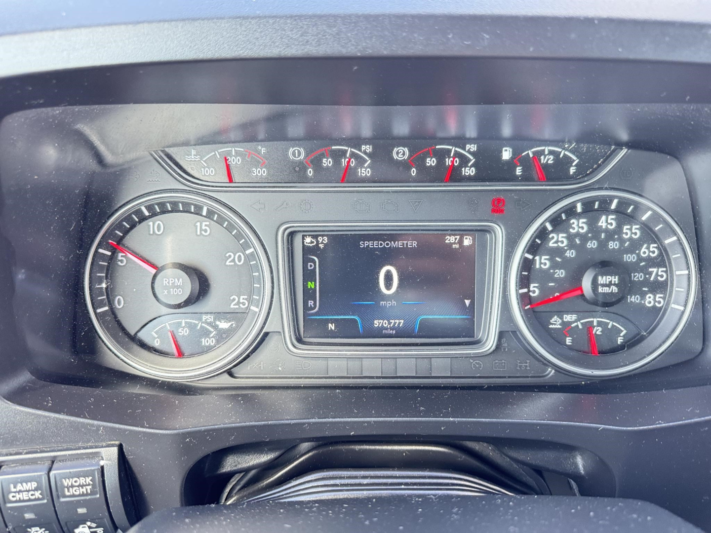 Dashboard of a 2020 International LT showing gauges including RPM, speedometer, the digital display reading 0 mph, and various warning lights; trim and steering wheel visible.