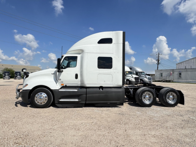 International LT truck side view showing sleeper cab and chassis with dual rear axles.