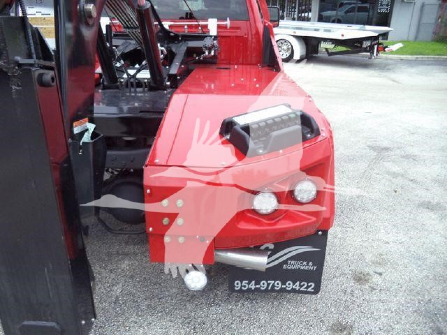 Ram 2024 Laramie winch-equipped truck front quarter showing red body, encased off-road bumper with fog lights and winch equipment.