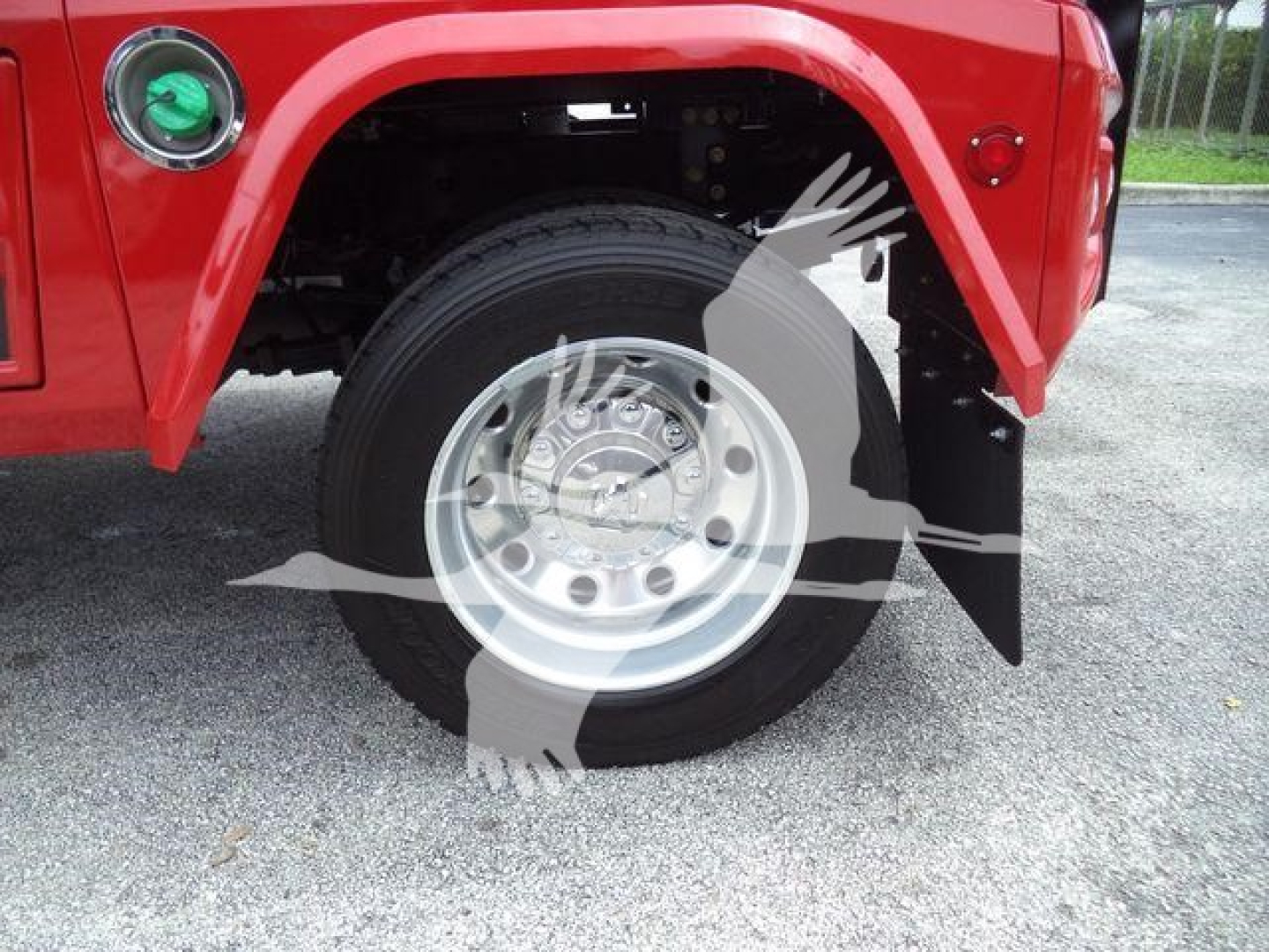 Ram truck wheel and fender view showing wheel, tire, and red body panel