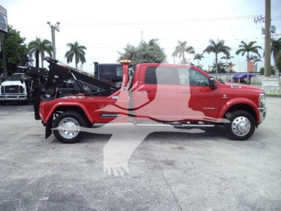 Side view of a red 2024 Ram 2500/Turbo RAM truck with a winch and tow attachment in a dealership lot.
