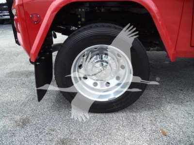 Ram truck wheel and fender showing chrome wheel, black tire, red body panel and wheel well.