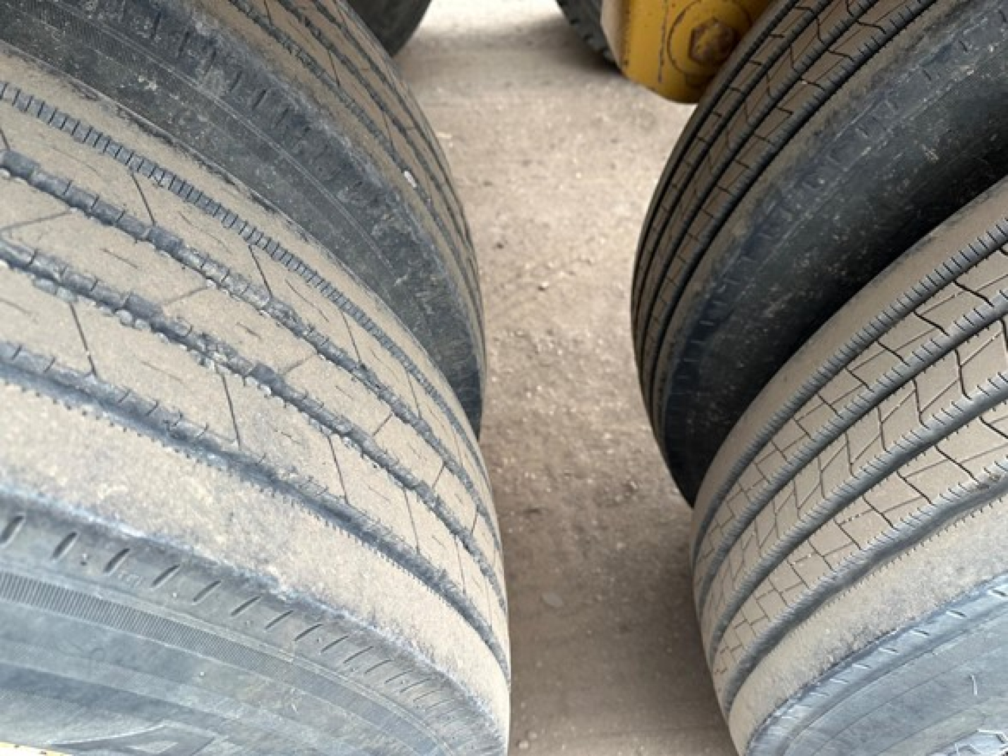 Tandem axle trailer tires showing tread and sidewalls, part of a Load King Originator Bottom Dump.