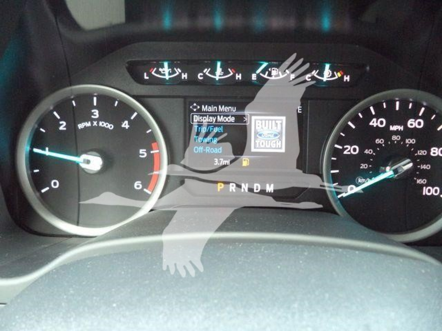 Dashboard view of a 2022 Ford F-550 instrument cluster showing speedometer, tachometer, and center display with 'Main Menu' and 'Tell Mode' text; gear selector indicator shows P R N D M.