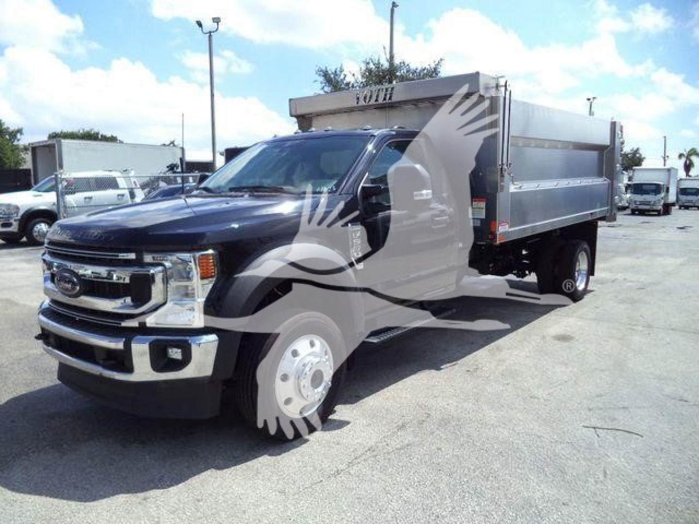 2022 Ford F-550 dump truck in a dealership lot, black cab with silver dump bed, front grille, side view; watermark overlay on image.
