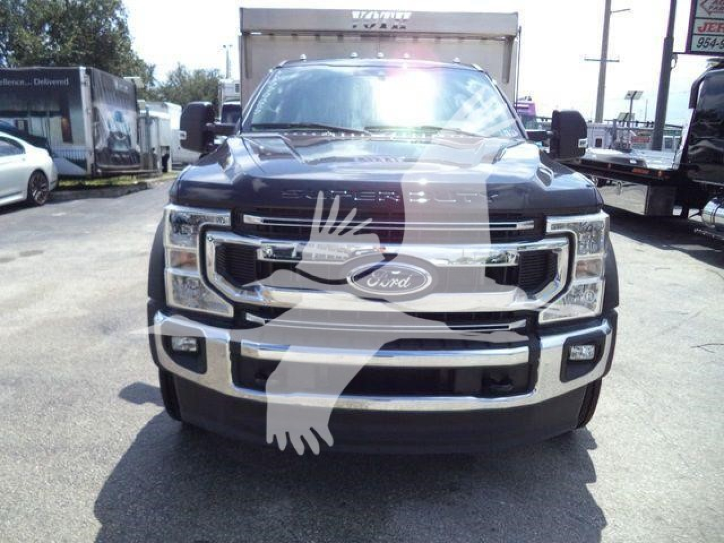 Ford F-550 front view showing grille, bumper, and headlights in a truck lot.